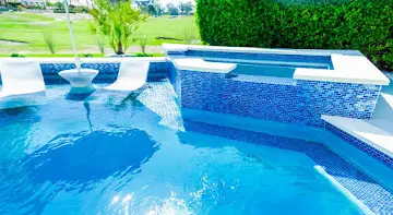 Blue mosaic tile spa with waterfall